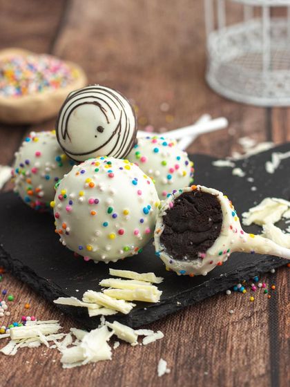 A closer look at my white chocolate cake pops. You can see the rich, fudgy cake inside, coated in a smooth layer of white chocolate and sprinkles.