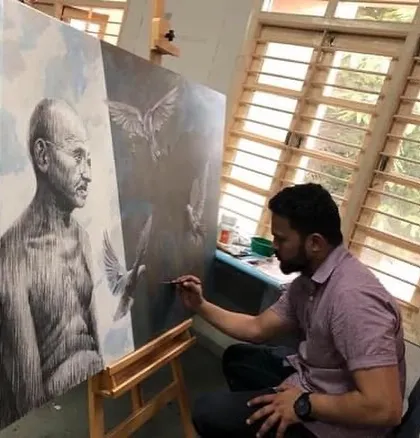 At work in the studio on the Gandhiji painting, which combines acrylic and charcoal on a 3ft x 4ft canvas.