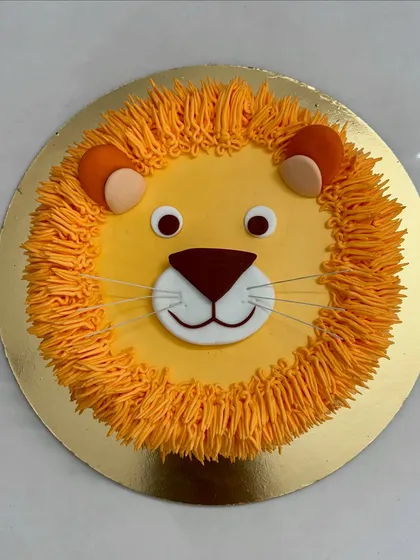 A top-down view of the friendly lion cake, showing off his sweet face. A great choice for a jungle or animal-themed party.