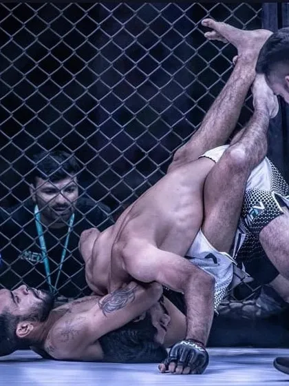 This is the reality of ground and pound in MMA. A powerful shot from MFN 3 in Mumbai, showing a fighter in a dominant position, working from the guard.