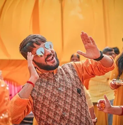 A guest dances and enjoys the Haldi function. We make sure to photograph not just the couple, but the entire vibe of the event and the happiness of the guests.