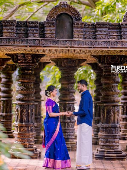 A couple in traditional South Indian attire in our stone pillar hall, a perfect setting for a culturally rich photoshoot.