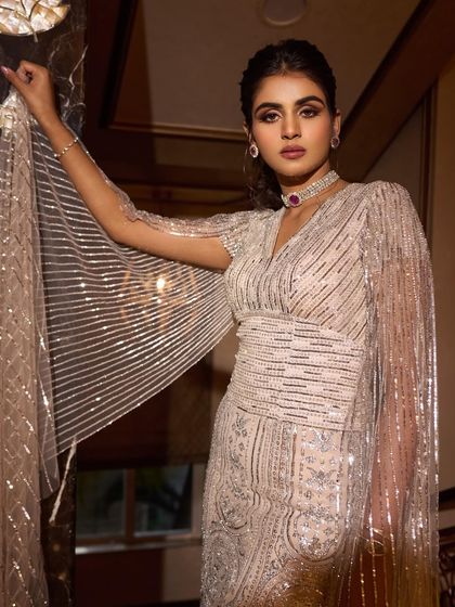 A throwback to this radiant engagement look. This fully embellished Falguni Shane Peacock gown with attached cape sleeves is a perfect example of modern glamour for a bride-to-be.