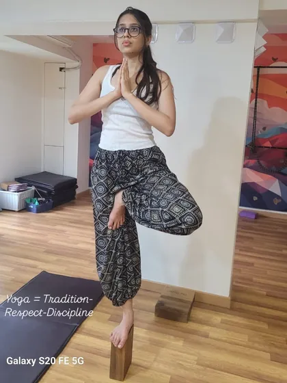 A student demonstrates Vrikshasana, or tree pose, using a block for stability and alignment. This image embodies the core values of my teaching: Parampara (Tradition), Pratishtha (Respect), and Anushasan (Discipline). These principles are the foundation of a true yoga practice.