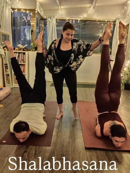Shalabhasana (Locust Pose) requires significant back and core strength. Here, my students are holding the pose, lifting their legs and chest off the floor.