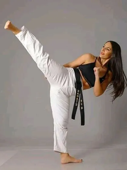 A black belt student demonstrates a clean, powerful side kick. This is a fundamental move in karate, and we focus on perfecting the basics.