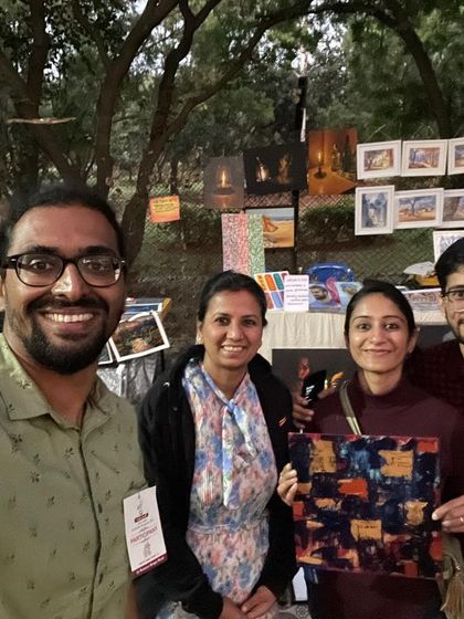 A selfie with my wife and the happy new owner of her painting.