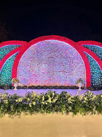 The stage viewed with floral arrangements in the foreground, adding layers and depth to the overall scene.
