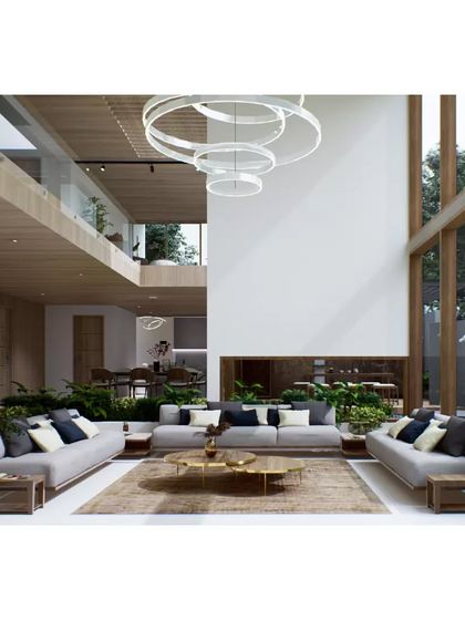 A 3D rendering of the Aakiri Residence living room. This visualization focuses on the interior atmosphere, showing the double-height space, material finishes, and connection to the garden.