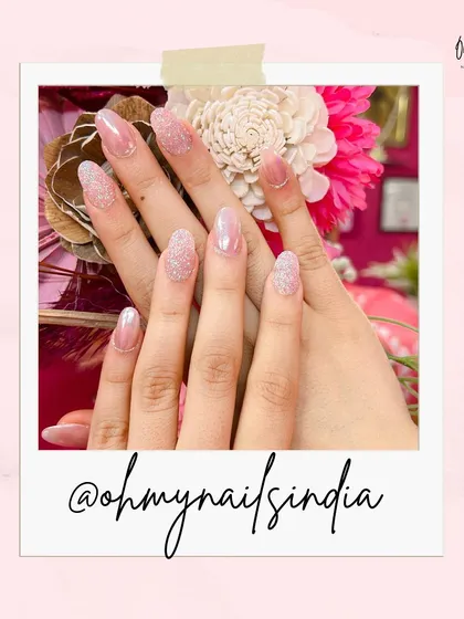 A simple and elegant set featuring a mix of sheer pink and sparkling glitter nails. This look is perfect for when you want a touch of glam without being over the top.