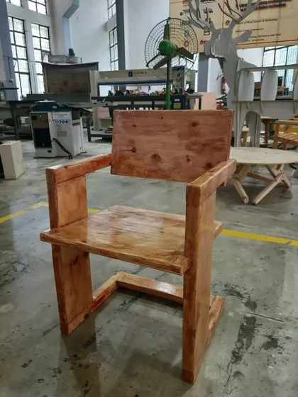 Built with strong, clean lines, this solid wood armchair is a testament to fundamental woodworking principles. The student focused on creating robust joinery and a functional form, resulting in a durable and timeless piece.
