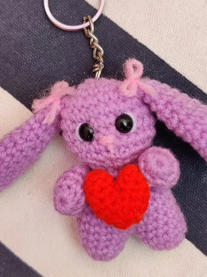 Adorable bunny keychains holding little red hearts, made for Valentine's but perfect for any time. I make them in brown, cream, pink, and purple.