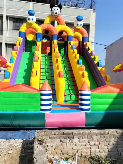 A 4-slider bouncy with a green and pink base, showcasing another custom color combination available for our multi-lane castles.