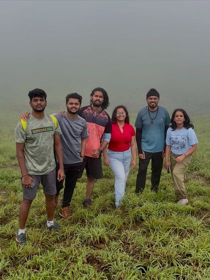 A group of friends posing on the grassy slopes of Gangadikal.