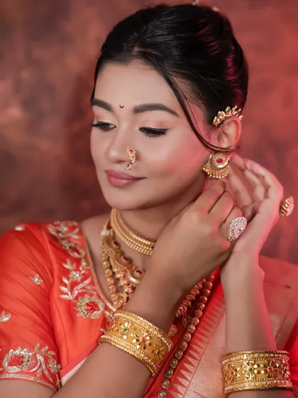 Adjusting the earring, this shot gives a great view of the side profile and the neat hairstyle.