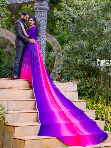 A tender moment on a stone staircase in the garden, with the flowing gown adding a touch of elegance.