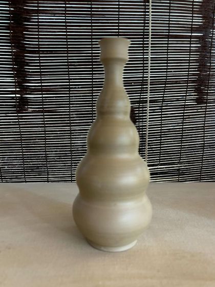 A collection of large, unglazed vases in various shapes and sizes. Each one is thrown on the wheel and showcases a different form, from classic curves to textured surfaces.