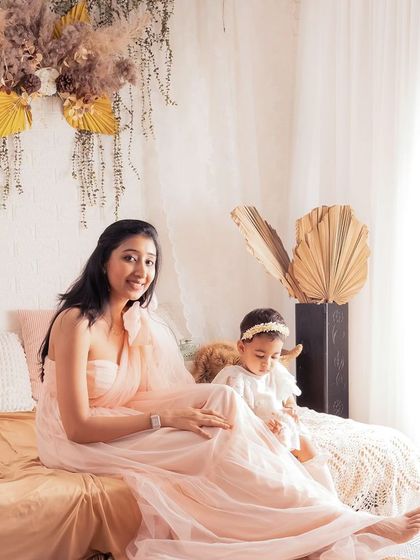 A lovely lifestyle portrait of a mother and her baby in our natural, bohemian studio setup. The warm light and earthy tones create a very serene and beautiful scene.