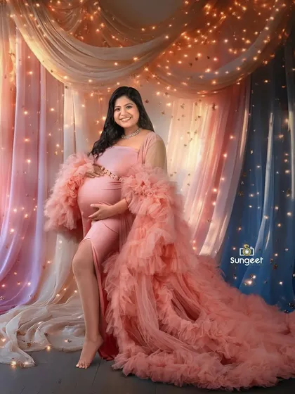 Our fairy light curtain backdrop adds a magical sparkle to this portrait. The mom-to-be looks stunning in a ruffled pink gown.