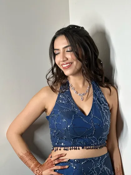 For a vibrant Sangeet night, we chose a glamorous look to match the energy. This style features sparkling eyes, flawless skin, and a bold red lip, paired with romantic curls to create a look that is both fun and absolutely stunning for the celebration.
