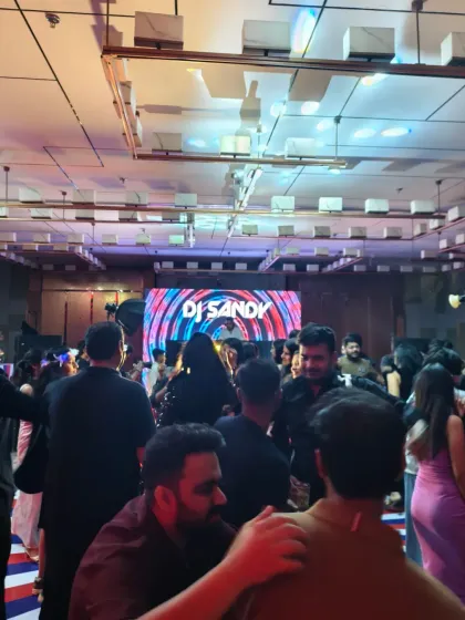 A packed dance floor with my name on the big screen. It's a great feeling to see everyone enjoying the music and celebrating together.