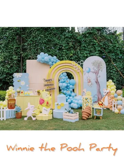 We journeyed into the Hundred Acre Wood for this charming Winnie the Pooh party. This full setup showcases our custom-designed backdrops, a rainbow arch, character props, and a themed cake area, all set up for a lovely outdoor celebration.