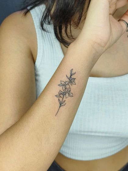 Another angle of the fine-line floral piece, showing its placement and delicate details.