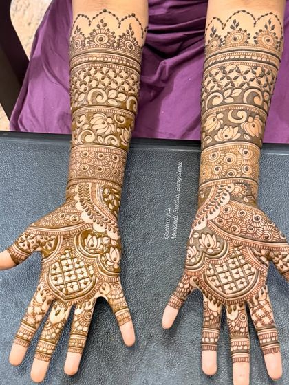 A slightly different angle of the same symmetrical bridal design, highlighting the consistency and precision in the patterns on both arms.