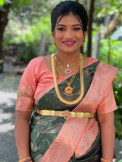 A classic portrait showing the flawless makeup and beautiful gold jewelry.