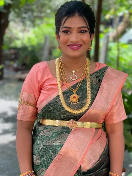A classic portrait showing the flawless makeup and beautiful gold jewelry.