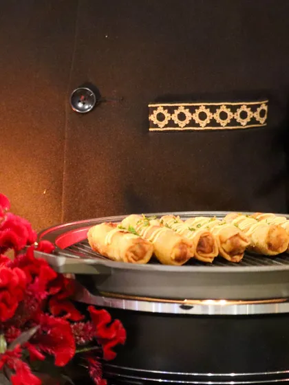 Crispy spring rolls, elegantly arranged and drizzled with sauce. A classic appetizer, executed with the finesse and style that defines our service.