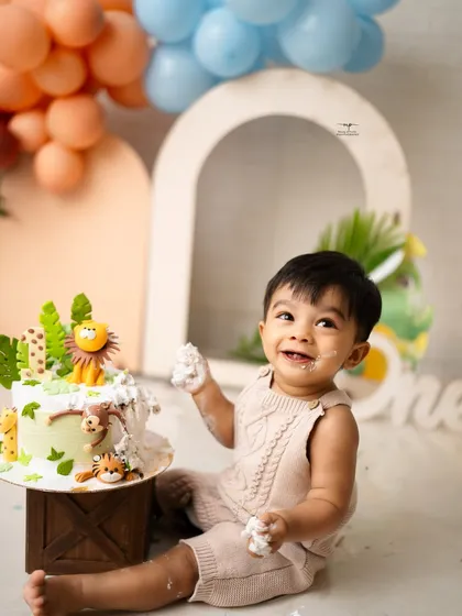 The pure, unfiltered joy of a first birthday cake smash. This is what it's all about: sweet smiles, messy fingers, and a memory that will be cherished long after the cake is gone.