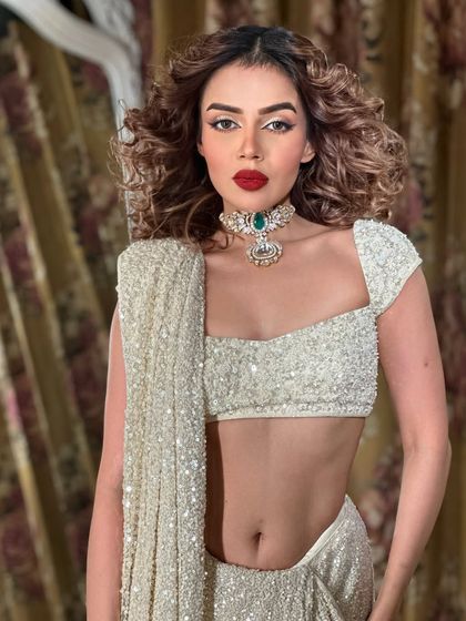 A full view of this stunning look. The white sequin saree is the perfect canvas for the bold makeup.