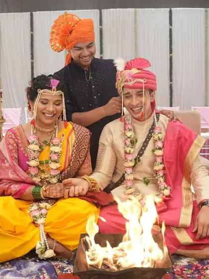 A candid moment of fun during the wedding rituals, showing the couple's relaxed and happy dynamic with their family.