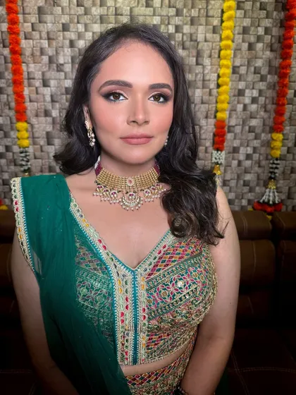 A vibrant and colorful look perfect for a Mehendi or Sangeet. This bride pairs her multi-colored lehenga with a simple yet elegant gold-tone choker, letting her outfit do the talking.