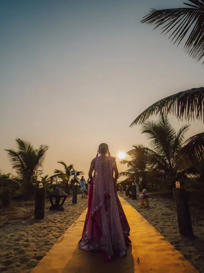A bride walking towards her destiny as the sun sets over a Goa beach. This silhouette shot is powerful and full of emotion, telling a story of a new beginning in a beautiful location.