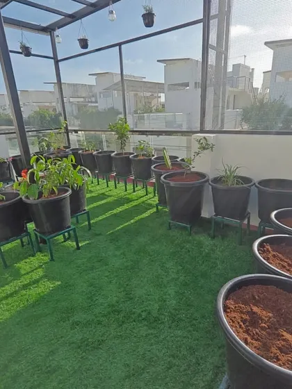 Here you can see a terrace garden in progress, with the artificial turf laid and pots ready for planting. This setup allows for a clean, soil-free environment that is easy to manage.