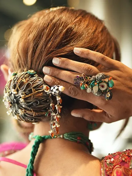 A close-up of the intricate hair accessory from a creative collaboration shoot. This piece from Purab Paschim's Safarnama collection adds a unique, eclectic touch to the bridal bun.