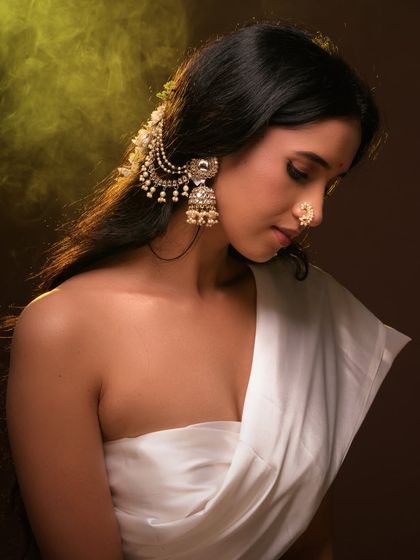 A beautiful ethnic portrait with a focus on traditional jewelry and styling. The warm lighting and serene expression create a timeless and graceful image.