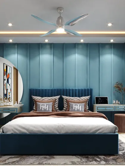 Your bedroom should be your personal sanctuary. Here, we've used a calming blue palette, a plush upholstered headboard, and layered lighting to create a tranquil and stylish retreat. This design balances bold color with soft textures for a perfectly serene master bedroom.