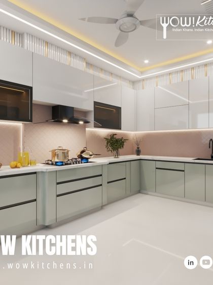 A look at one of our elegant designs, featuring handleless sage green and white cabinets, a patterned pink backsplash, and decorative fluted panels on the wall.