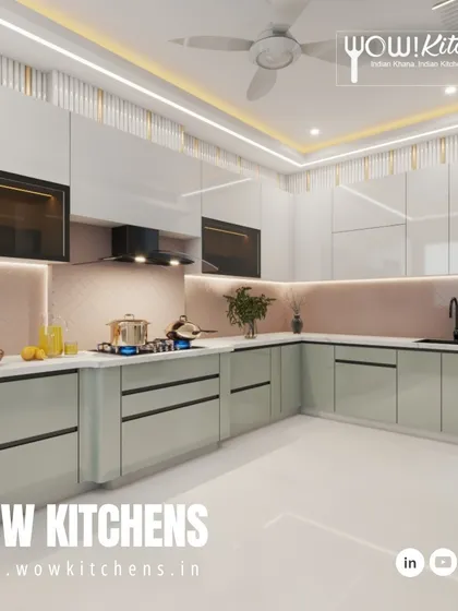 A look at one of our elegant designs, featuring handleless sage green and white cabinets, a patterned pink backsplash, and decorative fluted panels on the wall.