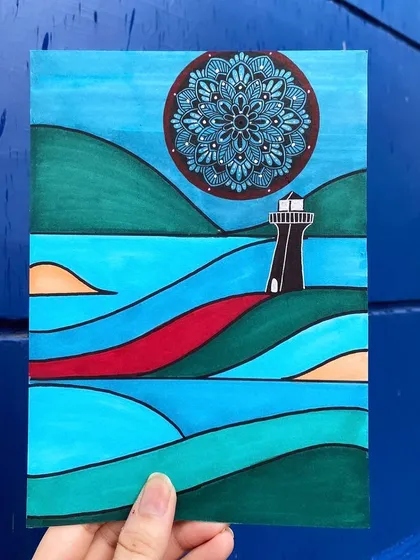 In this piece, a dark blue mandala acts as the sun or moon over a stylized coastal landscape. The clean lines and block colors of the scenery contrast with the intricate pattern of the mandala.