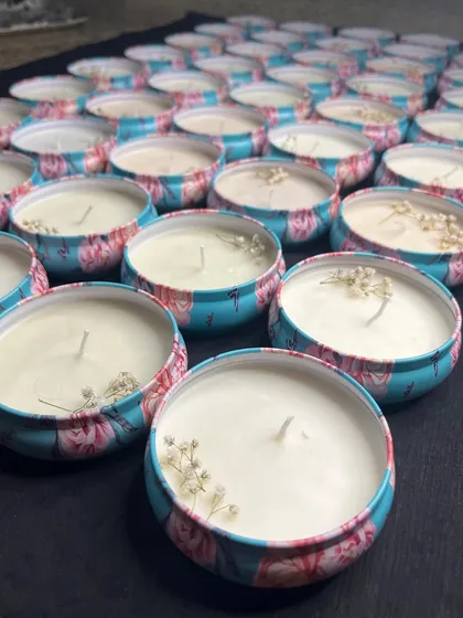 A large order of our floral tin candles, decorated with real dried baby's breath.
