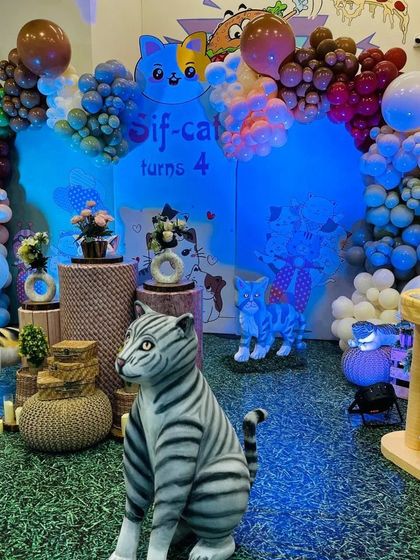 The cat party setup under blue lighting, creating a cool and moody atmosphere for the celebration.