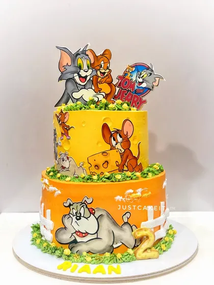 A two-tier Tom and Jerry cake with different scenes on each level. This cake uses printed edible images to capture the classic cartoon style.