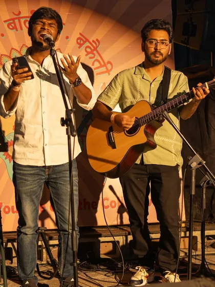 A duo of performers on stage, one on vocals and the other on guitar. This is where the magic begins at our open mic and jamming sessions.