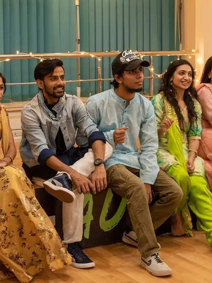 Our instructors and students taking a moment to watch performances during the Diwali celebration, all seated together like a close-knit family.