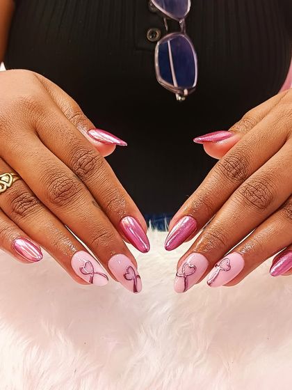 When chrome meets pink, the result is pure perfection. This set combines a stunning metallic pink chrome with softer pink accent nails featuring delicate bow art.