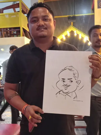 A guest at a restaurant event holding up his new caricature. A great way to remember a fun evening.
